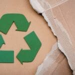 Recycling symbol on sustainable cardboard packaging materials.