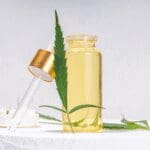 CBD oil cosmetic ingredient in a dropper bottle with cannabis leaf.