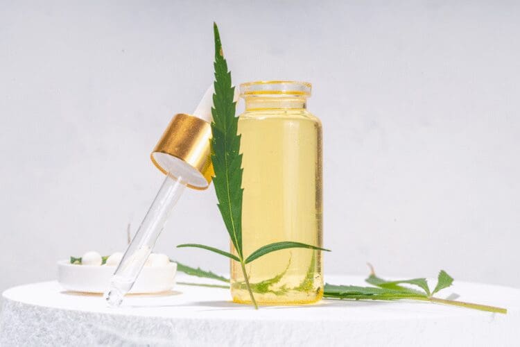 CBD oil cosmetic ingredient in a dropper bottle with cannabis leaf.