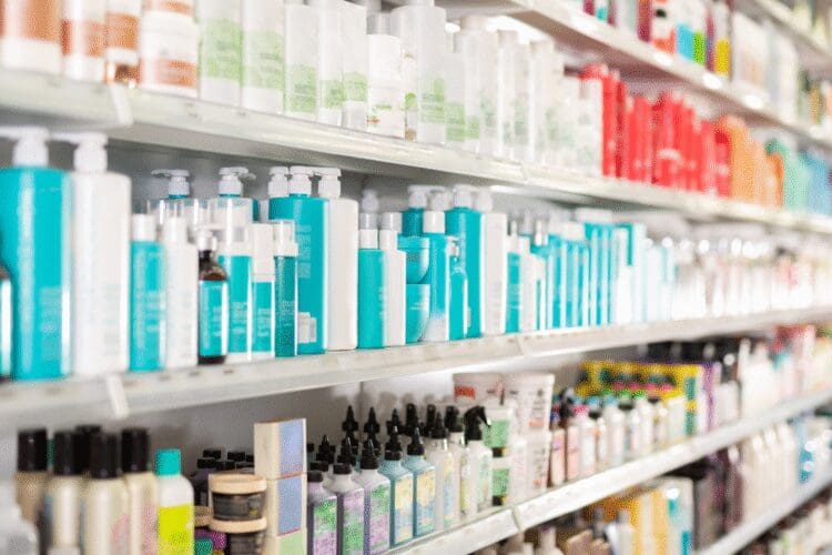 Cosmetic and personal care products displayed on retail store shelves.