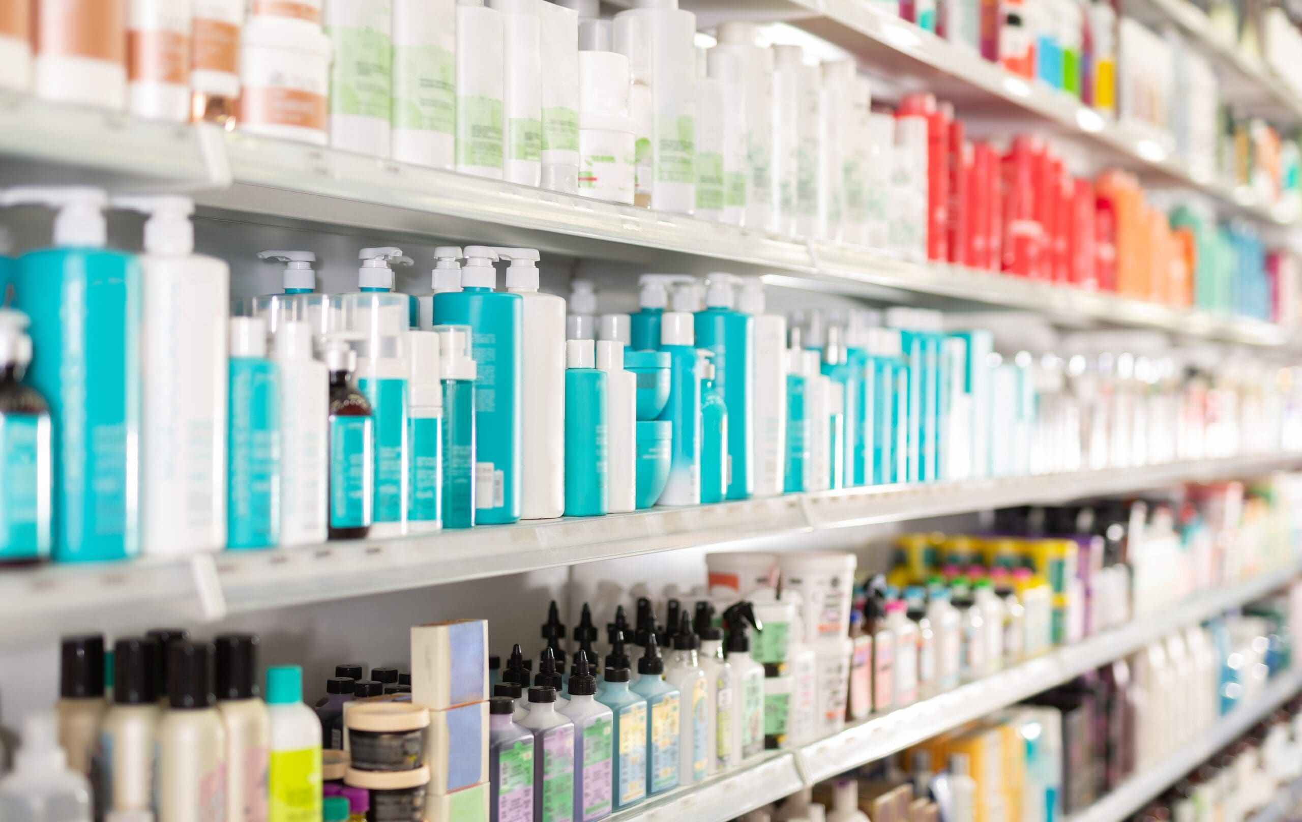 Cosmetic and personal care products displayed on retail store shelves.