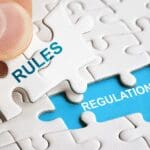 Puzzle pieces illustrating the connection between regulatory rules and compliance regulations.