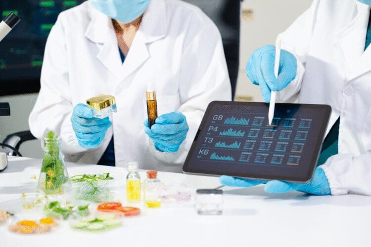 Scientists evaluating cosmetic formulations and skincare products in a laboratory.