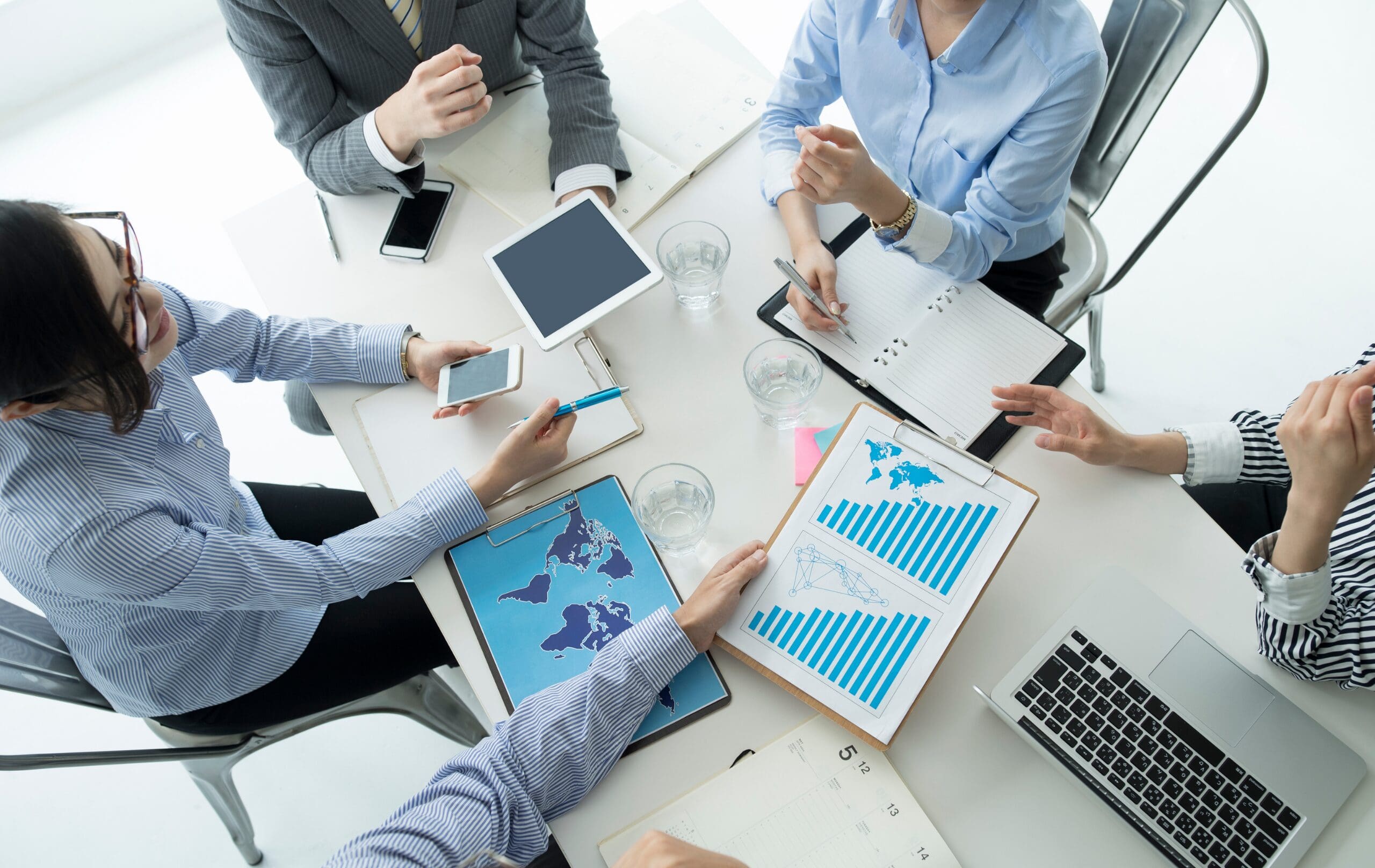 Business professionals discussing international regulatory compliance and market access strategies during a meeting.