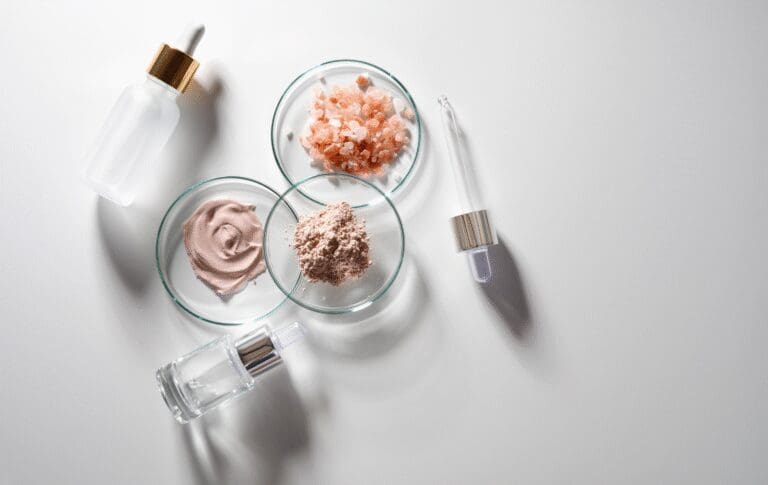 Cosmetic ingredients, skincare serum bottles and laboratory dishes used for cosmetic formulation.