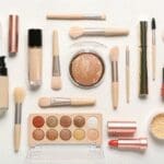 Selection of makeup and cosmetic products including lipstick, foundation, eyeshadow and powders.