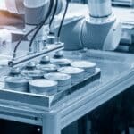 Automated industrial production line handling metal containers in a manufacturing facility.