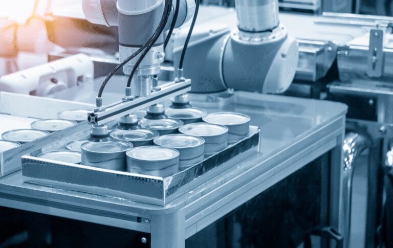 Automated industrial production line handling metal containers in a manufacturing facility.