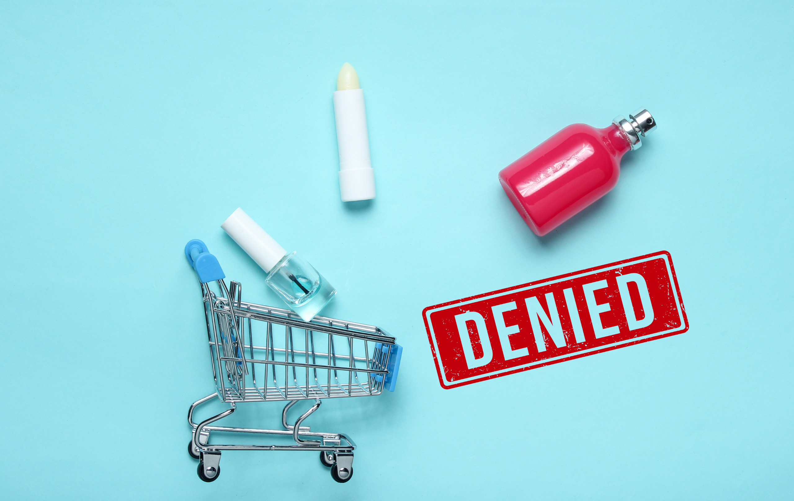 Cosmetic products and shopping cart beside a denied stamp representing market access restrictions.